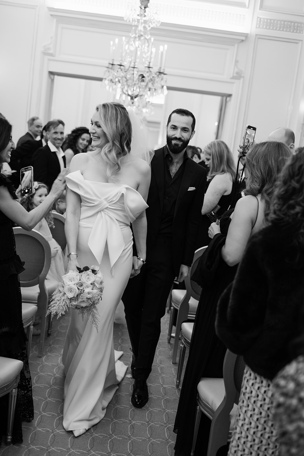 Bride and groom greeting guests after their Plaza Athénée wedding ceremony
